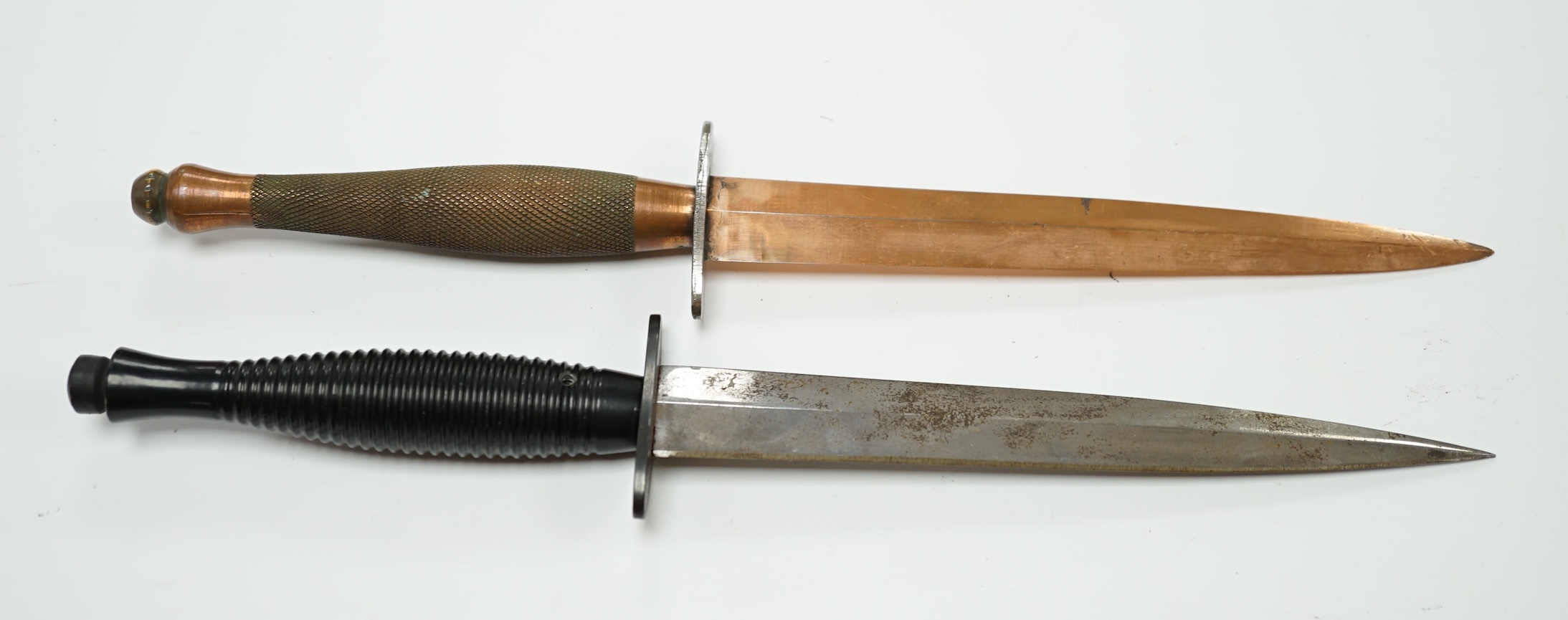 Two Fairburn Sykes style daggers, one copper plated, guard of the other stamped William Rogers, Sheffield, England. Condition - good